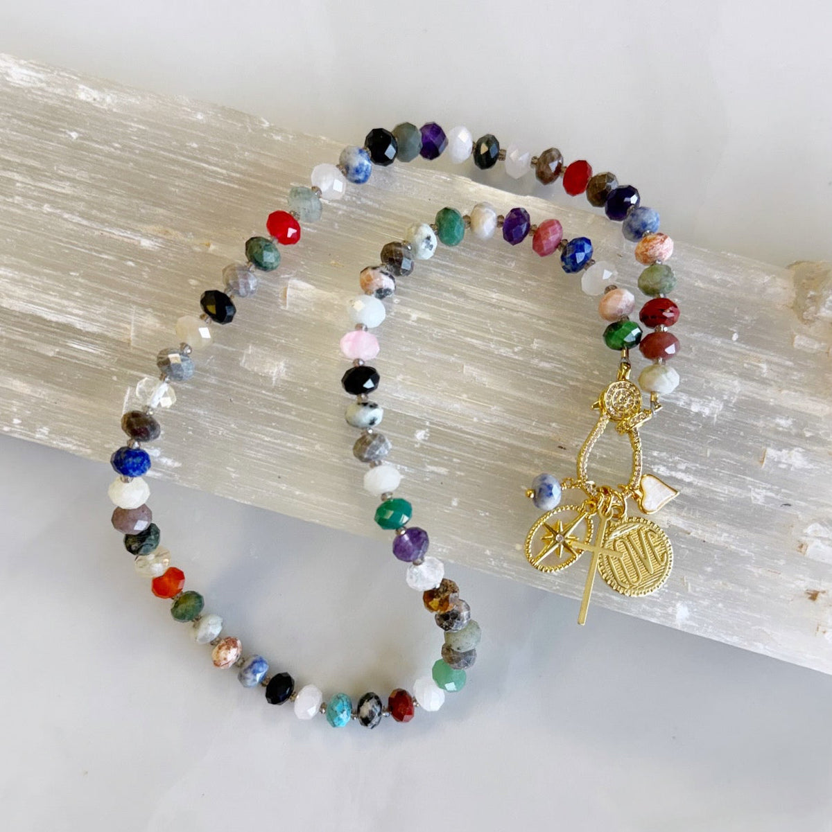 Free Spirit Gemstone Necklace has Tiger Eye, Amethyst, Sodalite, Onyx, Carnelian, Jasper, Turquoise beads plus much more! To make it extra unique it has a pave clasp in the front to hang charms from, and you can switch the charms on and off!